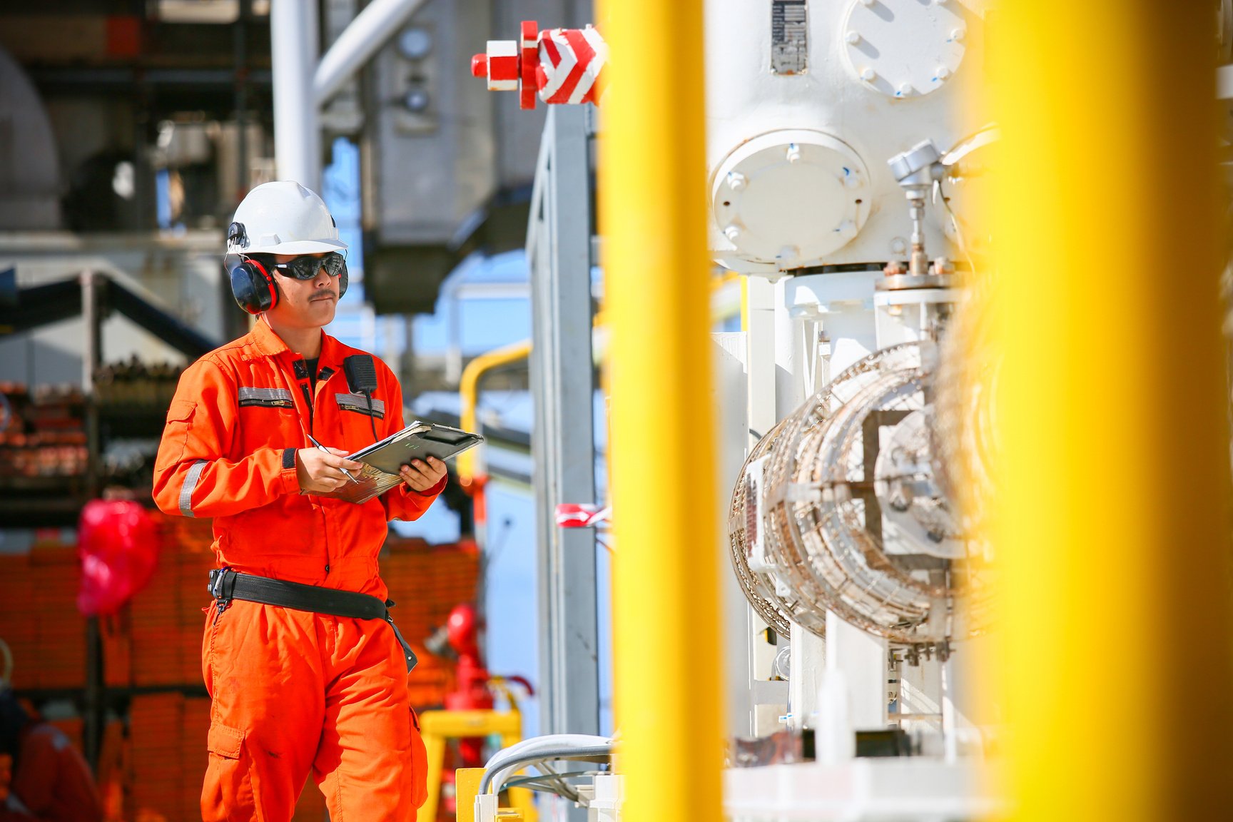 operator recording operation of oil and gas process at oil